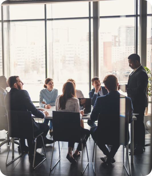 AI consulting meeting with a group of individuals sitting at a desk in front of a large window