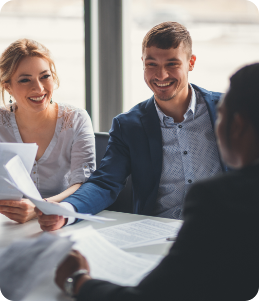 Group of people in a meeting and looking over paperwork