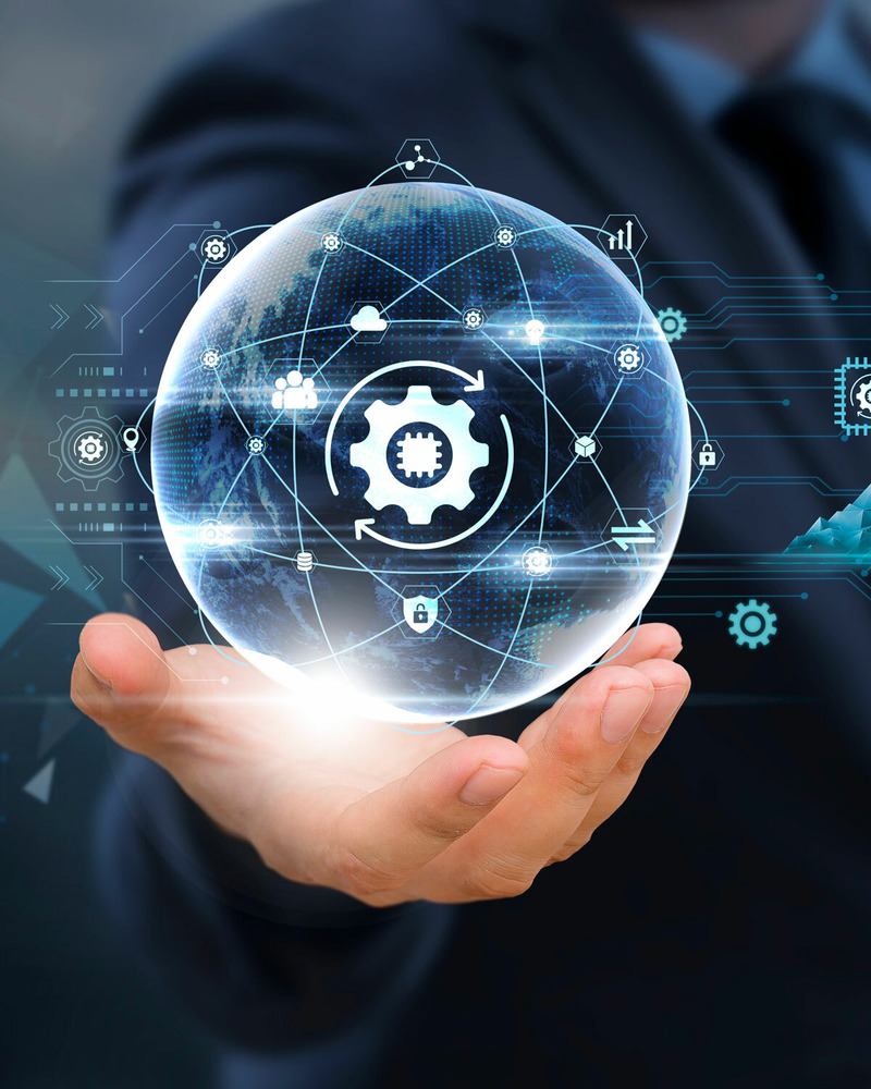 Digital illustration of a globe with icons and connected lines hovering above a person's open hand