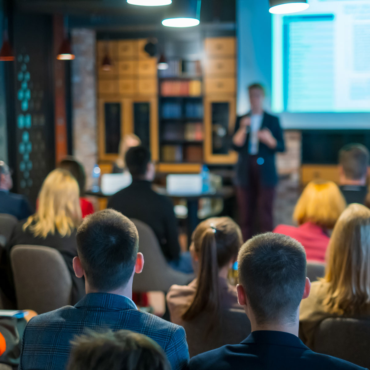 Students attending a lecture in a higher education setting.