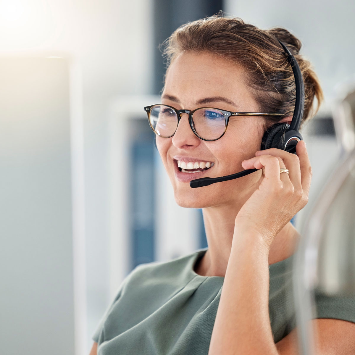 Customer service rep with headset providing AI-assisted banking support.